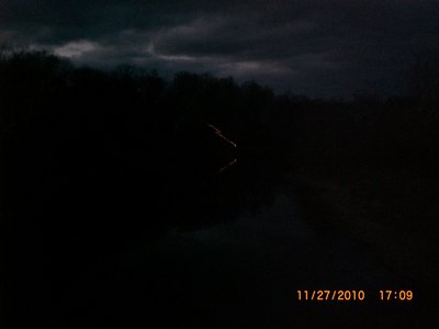 XMAS lights on a walkway down to the river and the reflection.