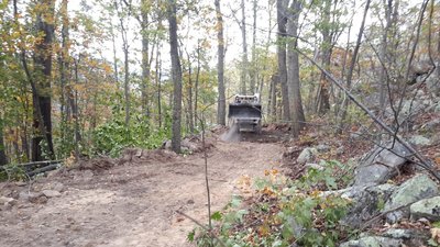 'Cat dumping a load of dirt along the trail to launch.