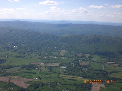 View of the winery at the lower left, just above the leftmost bare field.