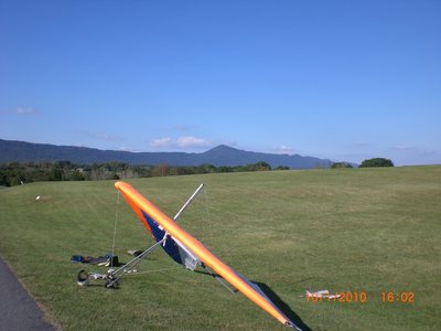 Glider parked in the rough, with Kennedy Peak in the distance.